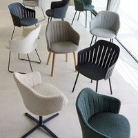 Assorted modern chairs in muted tones of gray, beige, black, and green, featuring various textures and patterns.