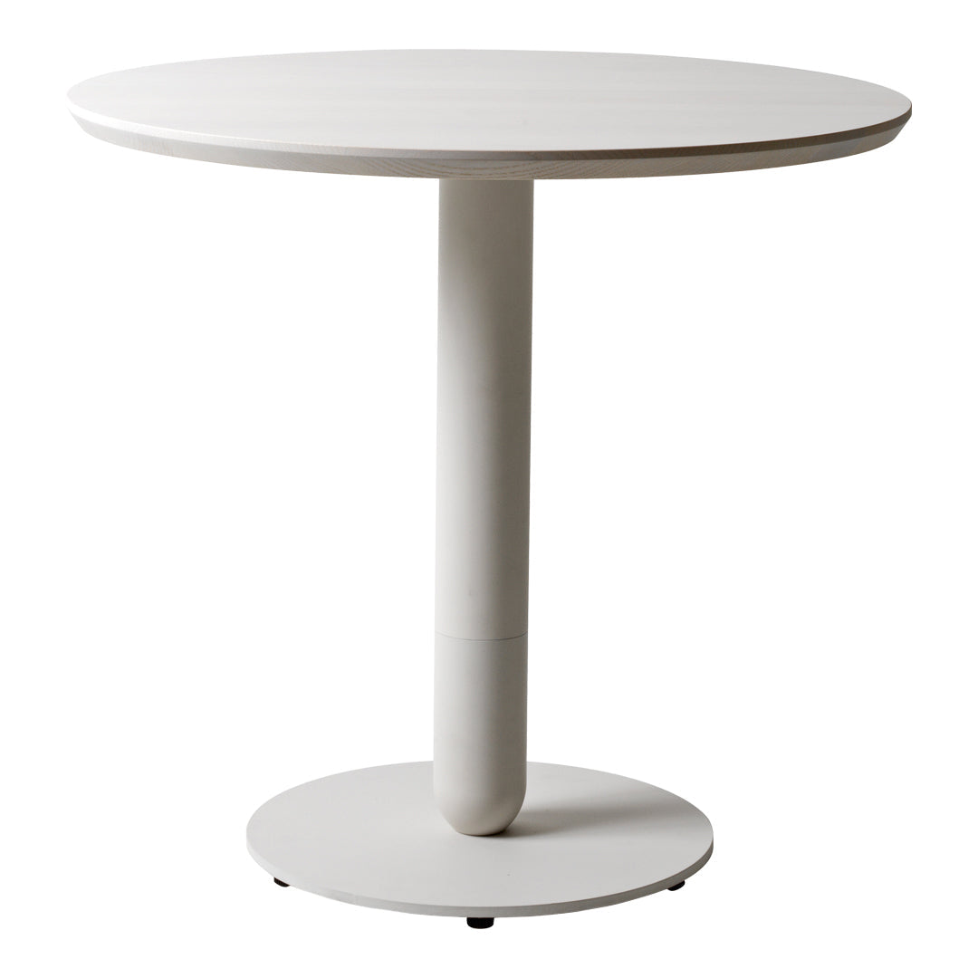 Round white dining table with a smooth finish and a minimalist design, featuring a solid circular base.