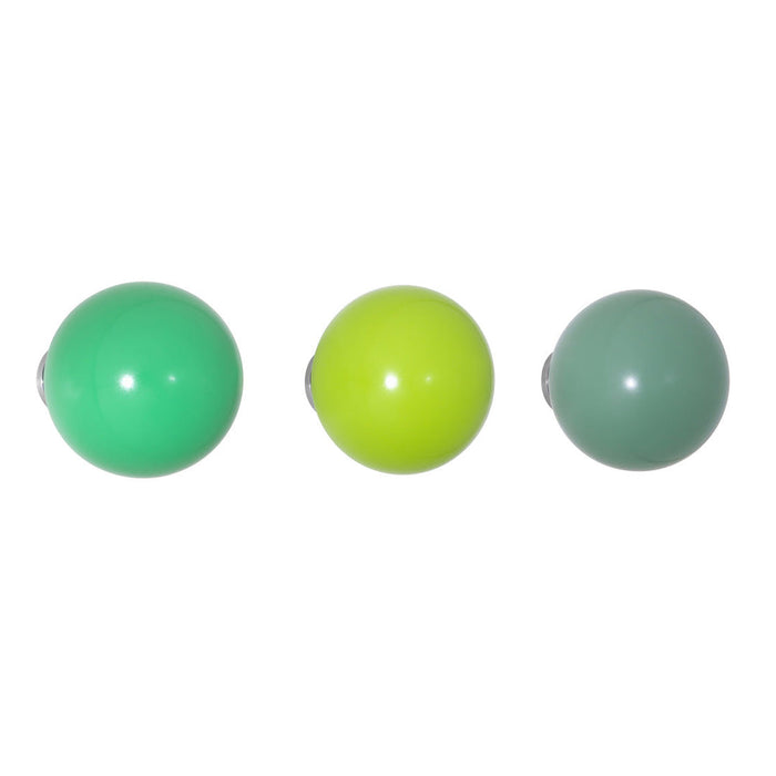 Shiny green, bright yellow, and muted gray-green decorative balls in a row, perfect for home decor.
