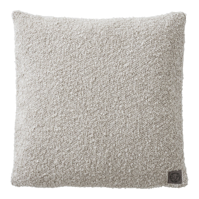 Textured beige throw pillow with a soft, cozy appearance, perfect for adding warmth to any decor.
