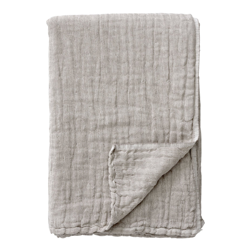 Soft, textured light gray blanket with a crinkled pattern, perfect for cozying up or adding style to any space.