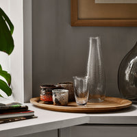 Glassware set featuring textured patterns in clear and frosted finishes, displayed on a natural wood tray.