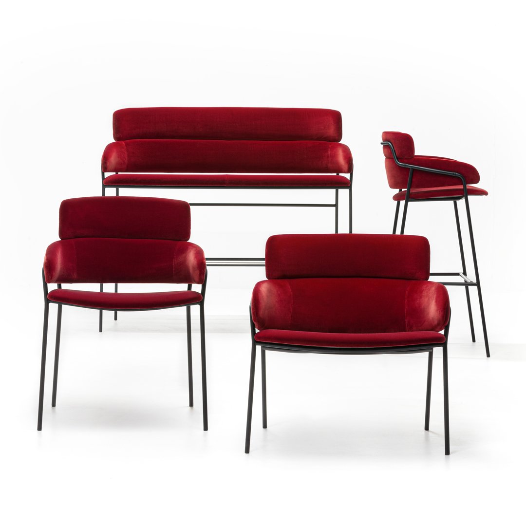 Set of four modern furniture pieces in rich red upholstery with sleek black metal frames.