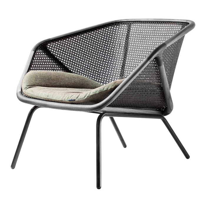 Modern black mesh chair with a light beige cushioned seat, featuring geometric patterns and sleek metal legs.
