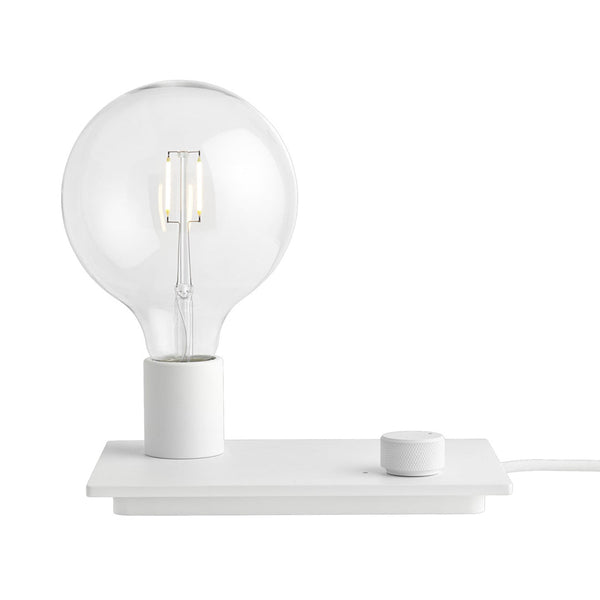 Minimalist white table lamp with a clear glass bulb and simple round base, featuring a sleek design and modern aesthetics.