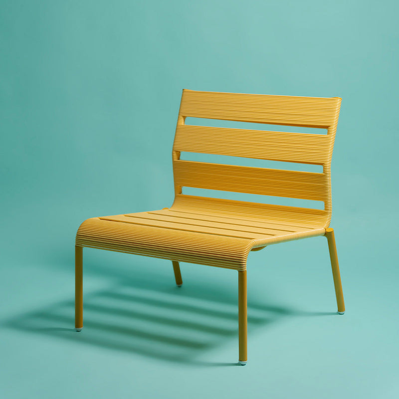 Bright yellow slatted chair against a soft turquoise background, showcasing a modern and vibrant design.