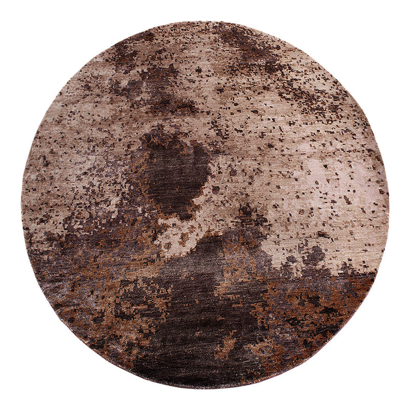 Round area rug featuring earthy tones of brown and beige with a textured, abstract pattern. Perfect for modern decor.