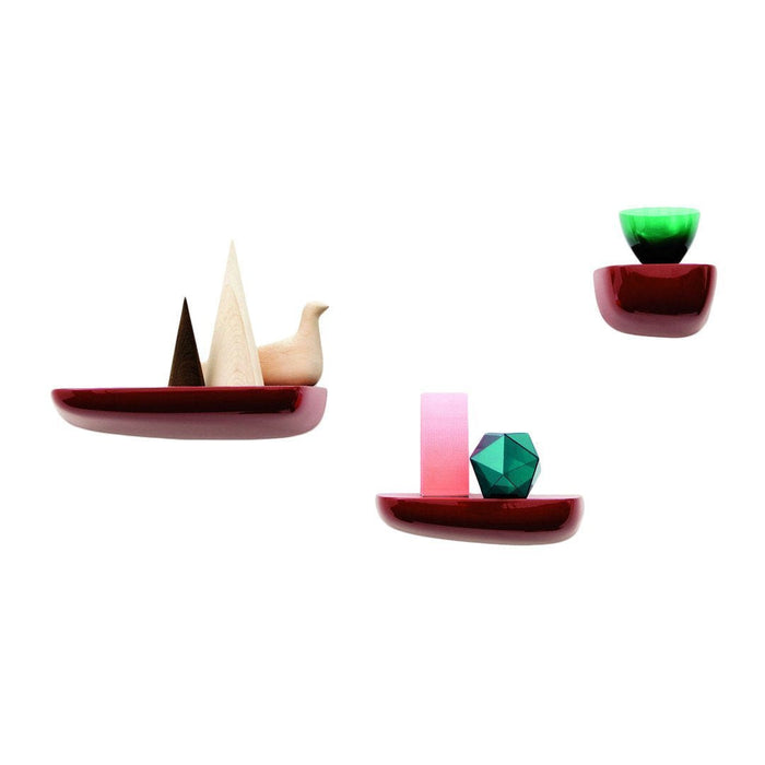 Colorful geometric designs on red shelves, featuring pink, green, and natural wood accents. Modern and playful decor.