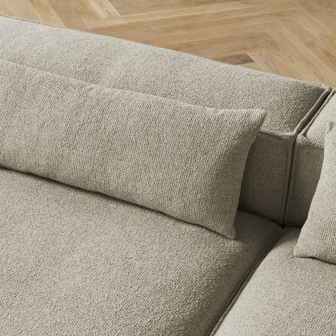 Beige textured fabric sofa with soft cushions, featuring a subtle, woven pattern. Ideal for modern living spaces.
