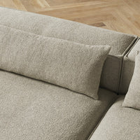 Beige textured fabric sofa with soft cushions, featuring a subtle, woven pattern. Ideal for modern living spaces.