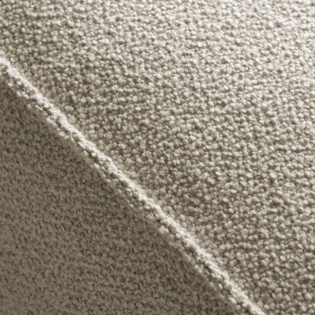 Textured fabric in soft beige with a subtle, knitted pattern, perfect for modern home décor.