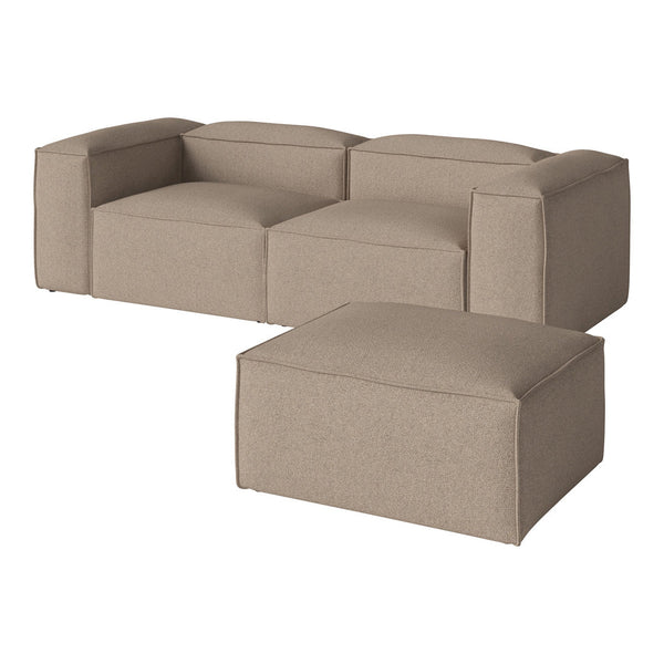 Beige contemporary sofa with smooth, solid fabric and clean lines, featuring a matching ottoman. Perfect for modern decor.