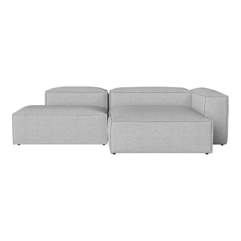 Light gray sectional sofa with minimalist design and soft fabric texture, featuring clean lines and a modern aesthetic.
