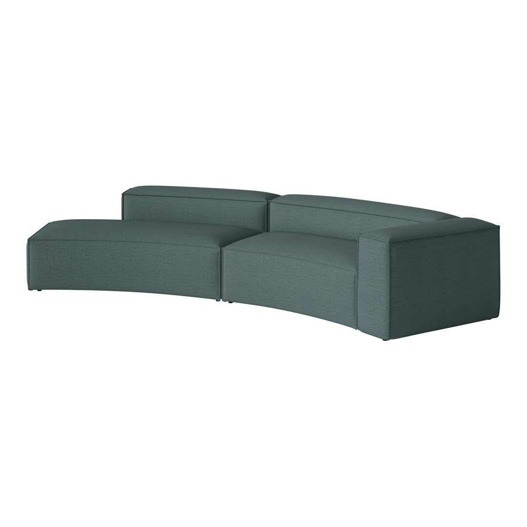 Teal curved sectional sofa with a textured fabric, featuring a minimalist design and clean lines.