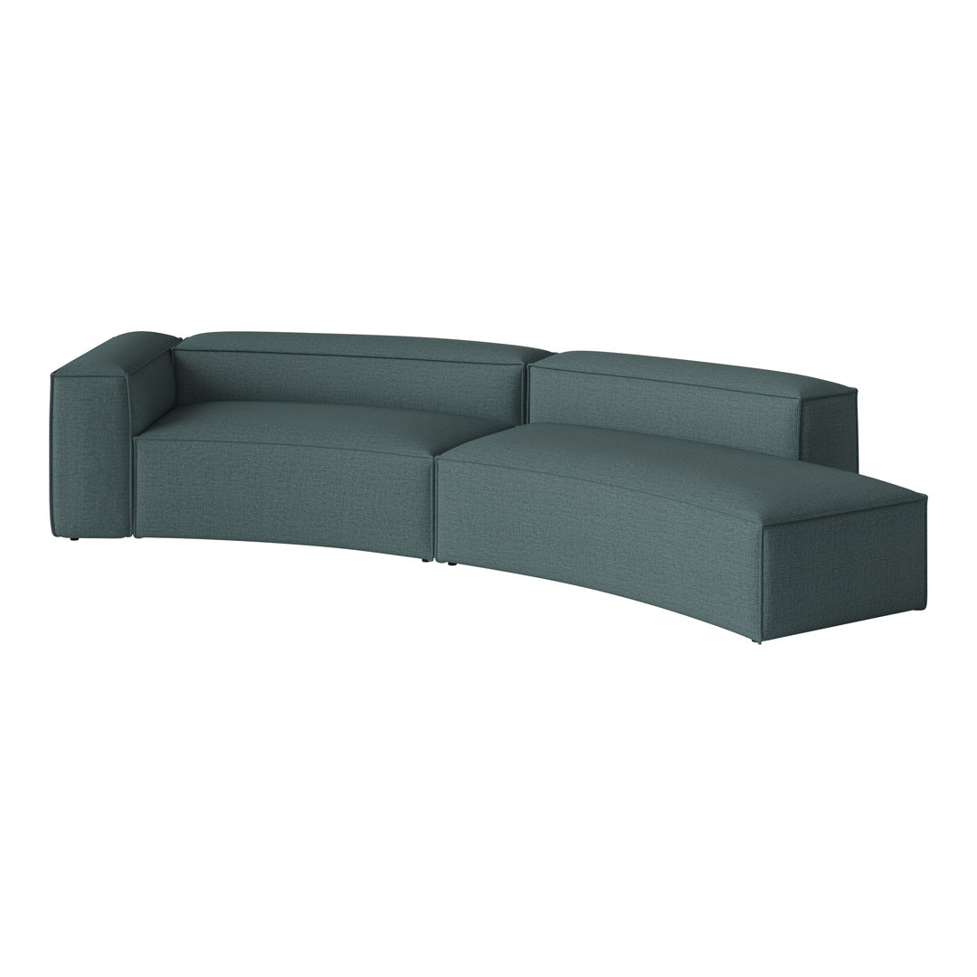 Curved teal sofa with a textured fabric, featuring a modern minimalist design and clean lines. Ideal for contemporary decor.