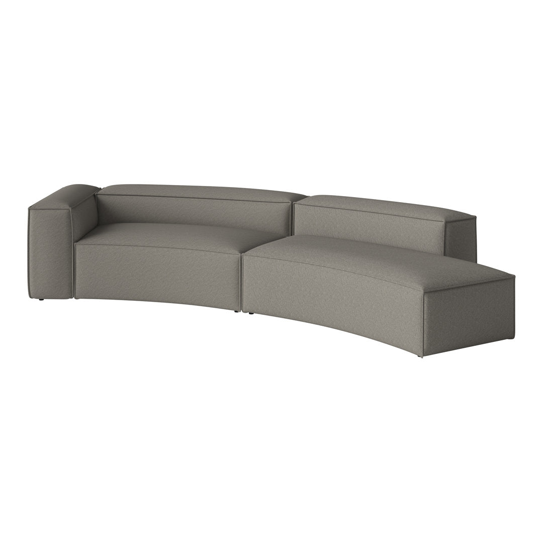 Curved modern sofa in soft gray fabric, featuring a sleek, minimalist design with clean lines and no visible patterns.