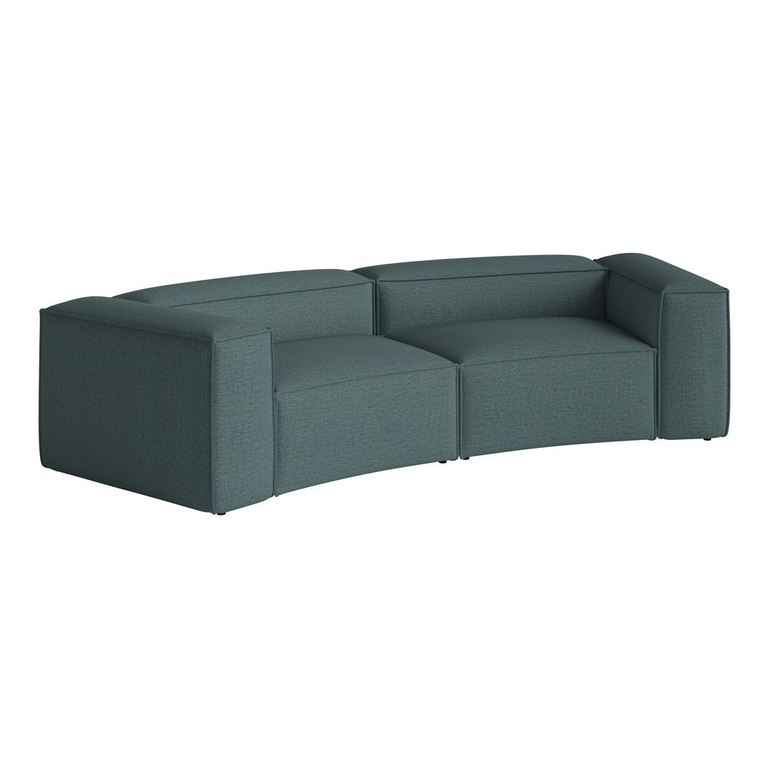 Curved teal sofa with a textured fabric pattern, featuring clean lines and modern silhouette. Ideal for contemporary living spaces.