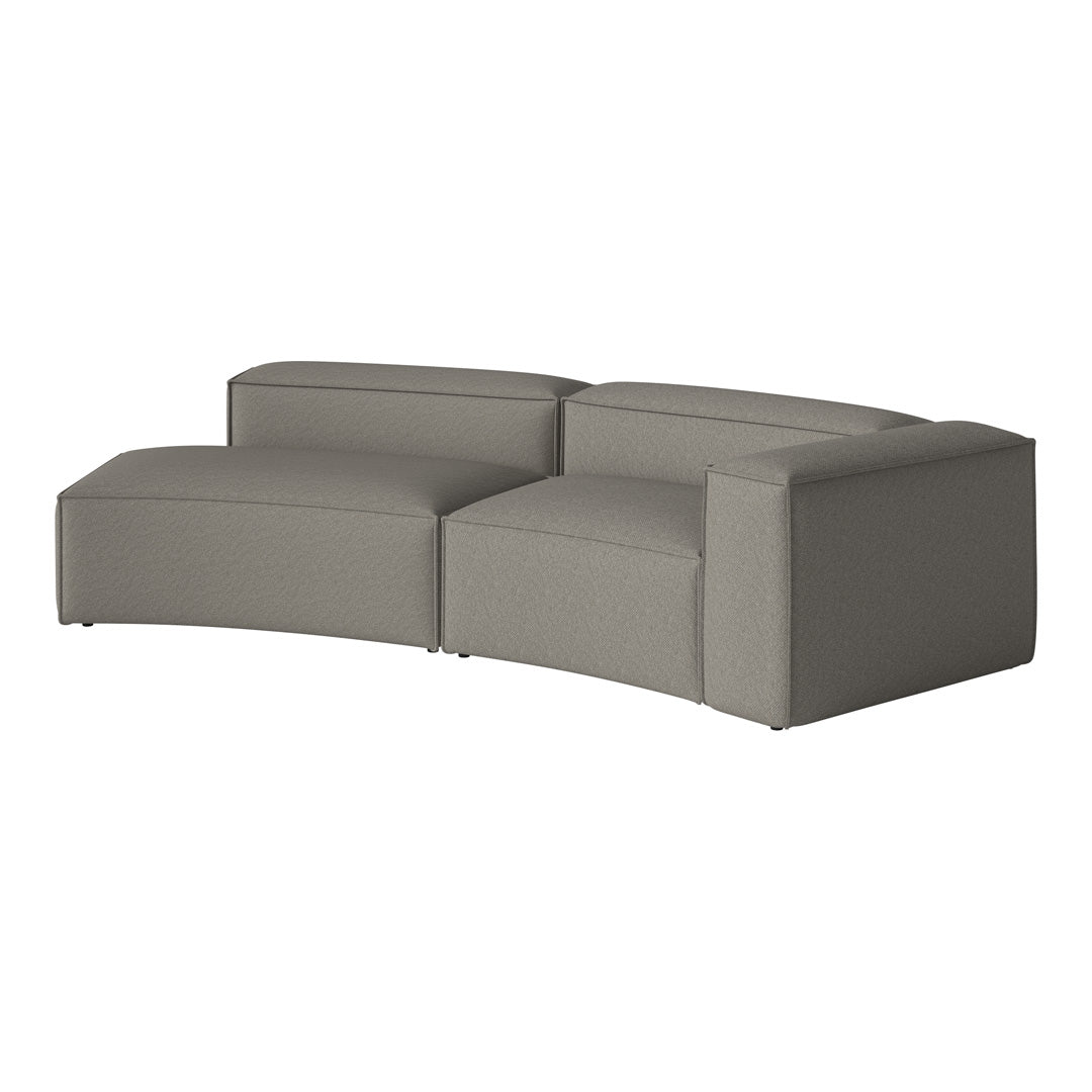 Curved grey sofa with a textured fabric finish, featuring a minimalist design and soft, muted tones.