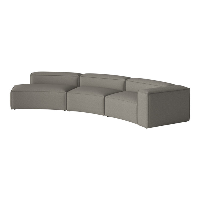Curved modular sofa in soft grey fabric with a smooth, textured surface. Ideal for modern living spaces.