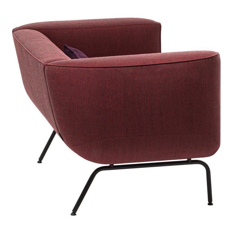 Burgundy fabric armchair with smooth contours and black metal legs. Stylish design ideal for modern decor.