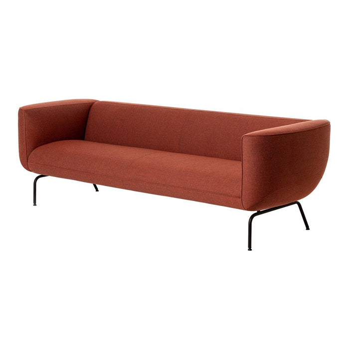 Rust orange sofa with a smooth texture and modern curved design, featuring black metal legs.