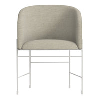 Light beige upholstered chair with a minimalist white metal frame, featuring a smooth, curved back design.