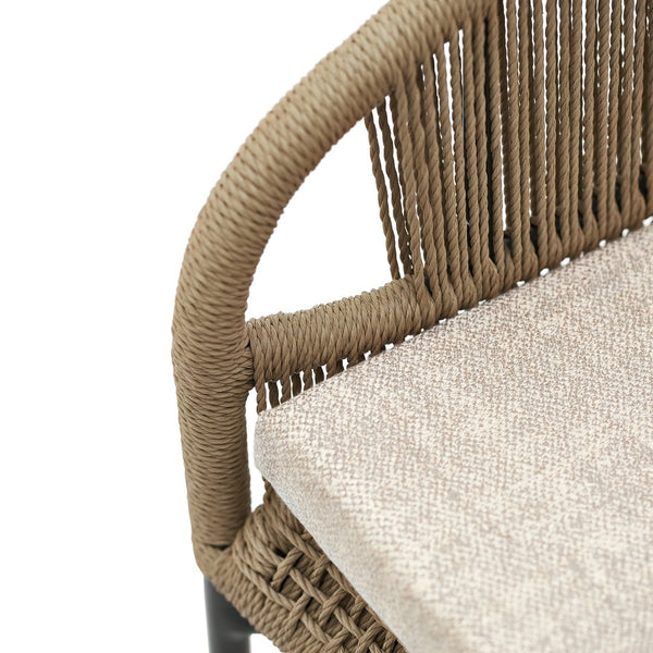 Brown woven chair with a textured finish and neutral beige cushion, showcasing a modern, stylish pattern.