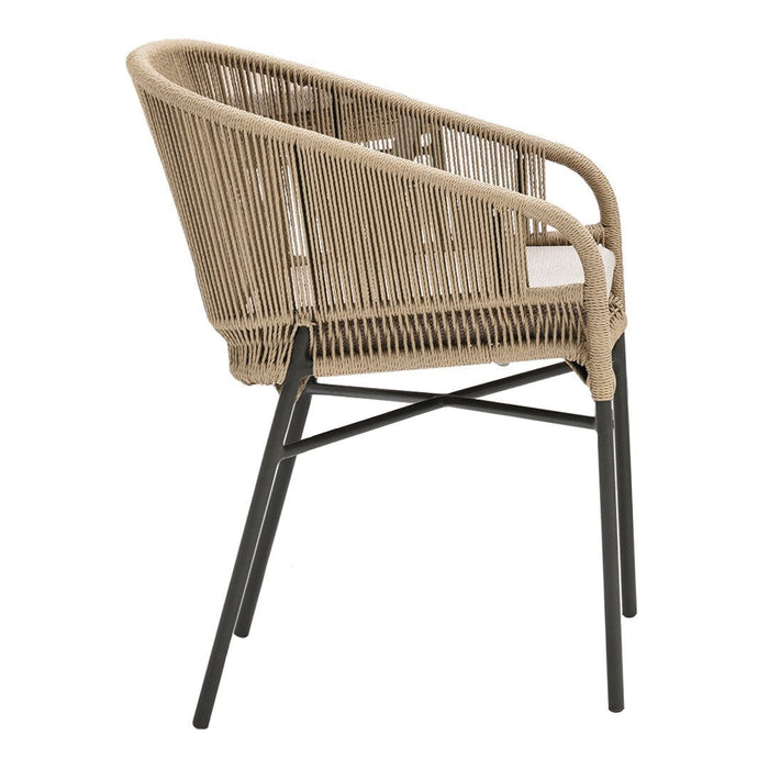 Tan wicker chair with black metal legs, featuring a sleek and modern design. Perfect for minimalist décor.