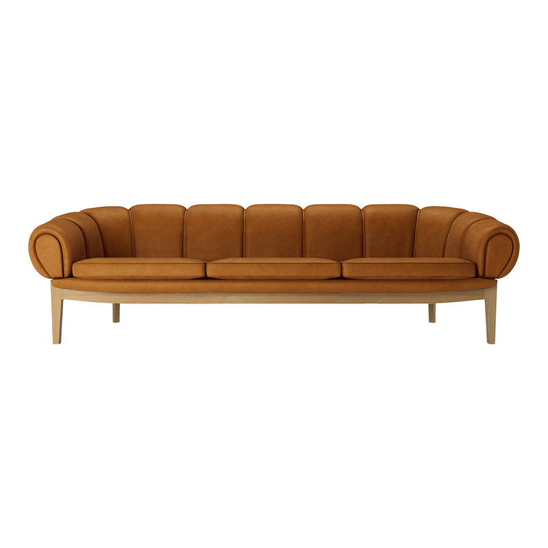 Mid-century modern sofa in warm brown tone with rounded arms and plush cushion design resting on light wooden legs.