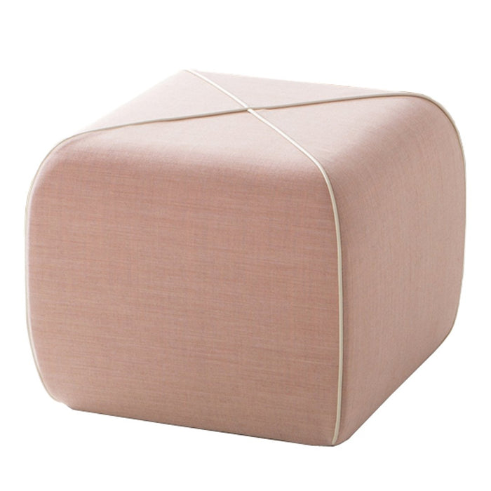 Soft pink fabric pouf with clean lines and subtle crosshatch texture, accented by a white trim. Ideal for modern decor.
