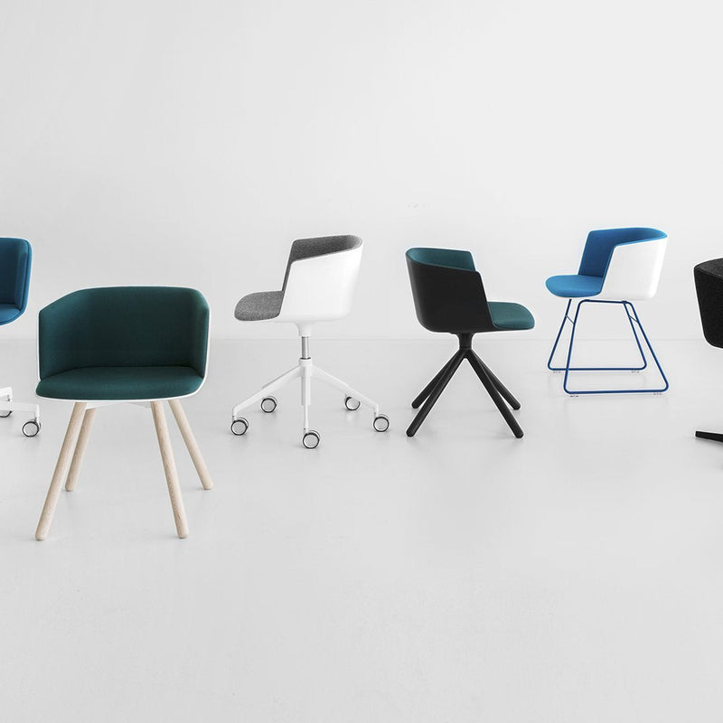 Colorful modern office chairs in teal, black, white, and blue with varied patterns and leg styles on a minimalist background.