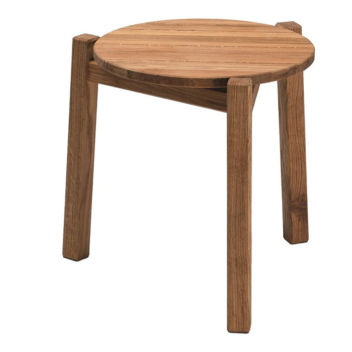 Round wooden stool in warm brown tones with a smooth, natural wood grain finish. Simple and modern design.