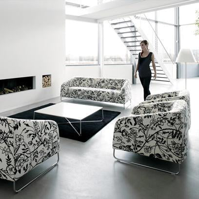 Black and white floral patterned sofas in a contemporary living space with minimalist decor.