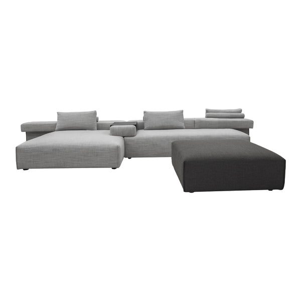 Gray sectional sofa with varied textured patterns and coordinated cushions in light and dark shades.