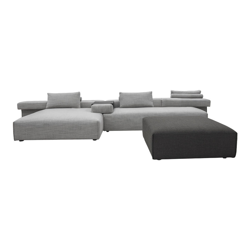 Gray sectional sofa with varied textured patterns and coordinated cushions in light and dark shades.