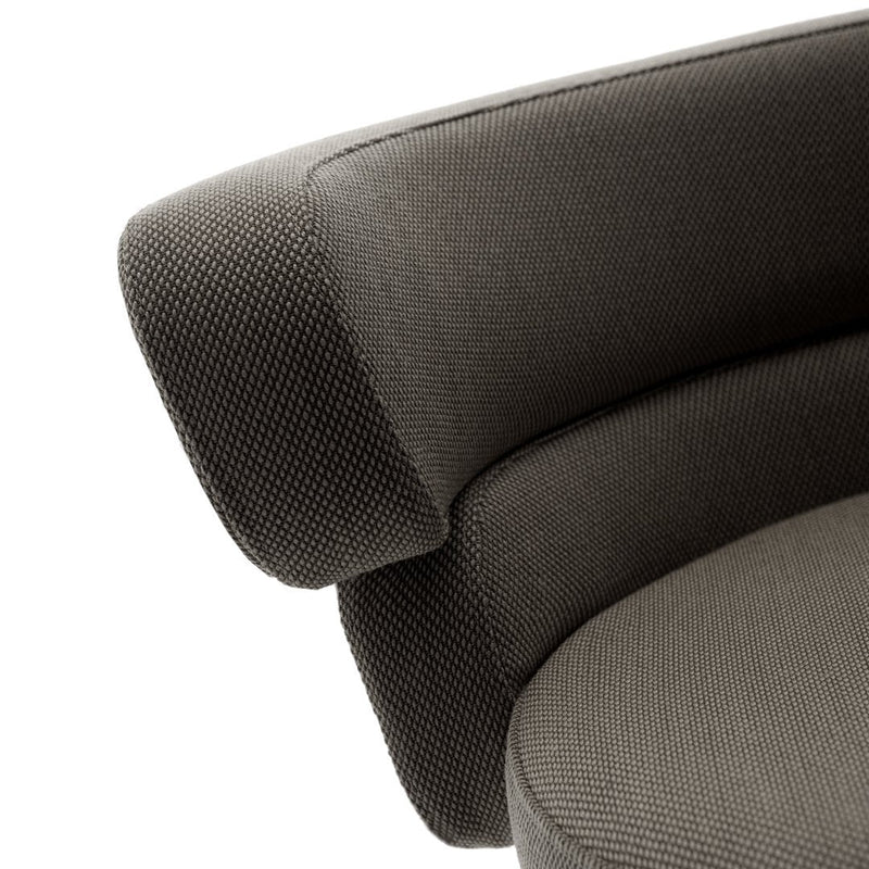 Textured dark gray upholstery with subtle patterns on a modern curved armchair.
