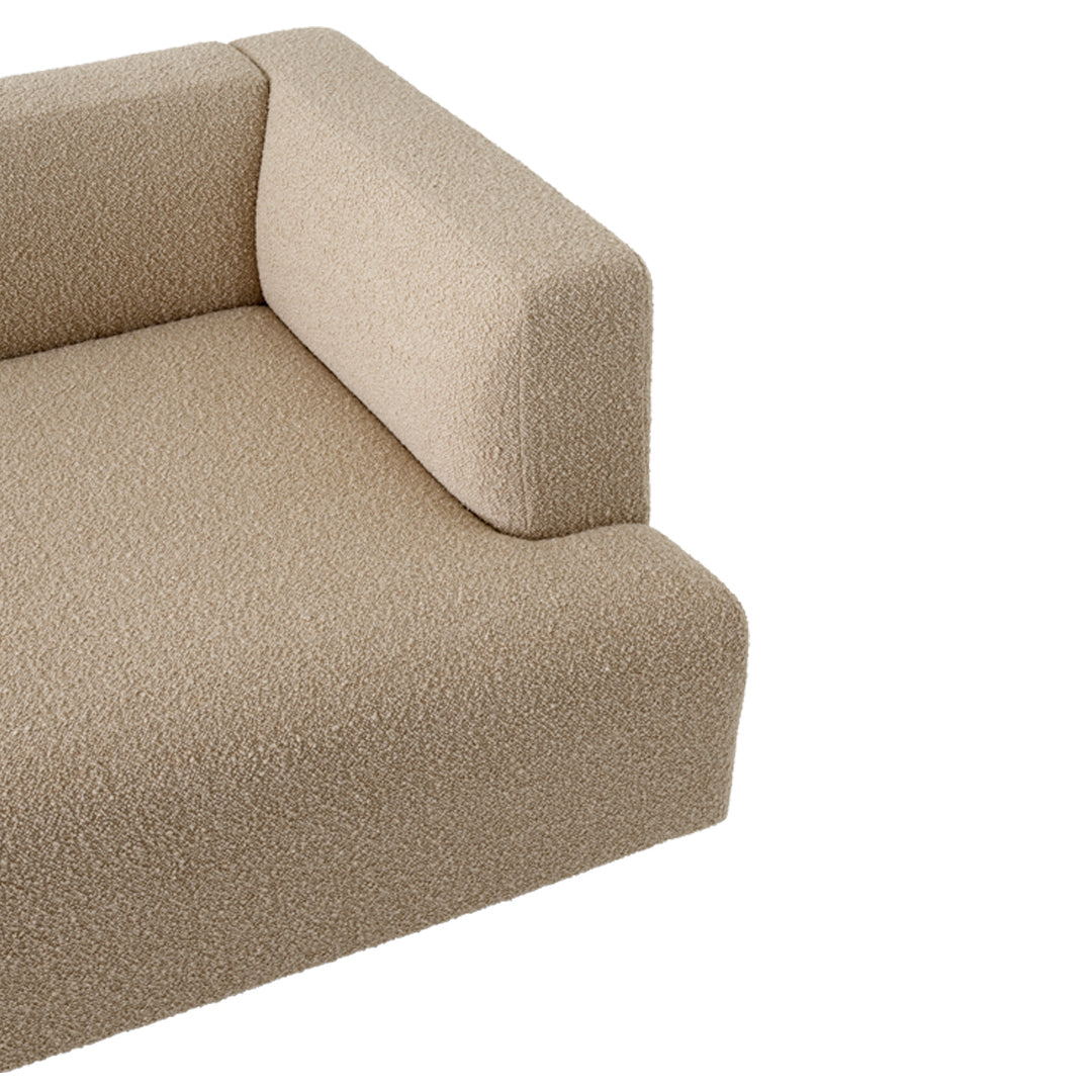 Soft beige sofa corner with textured, cozy fabric, perfect for modern and minimalist interiors.