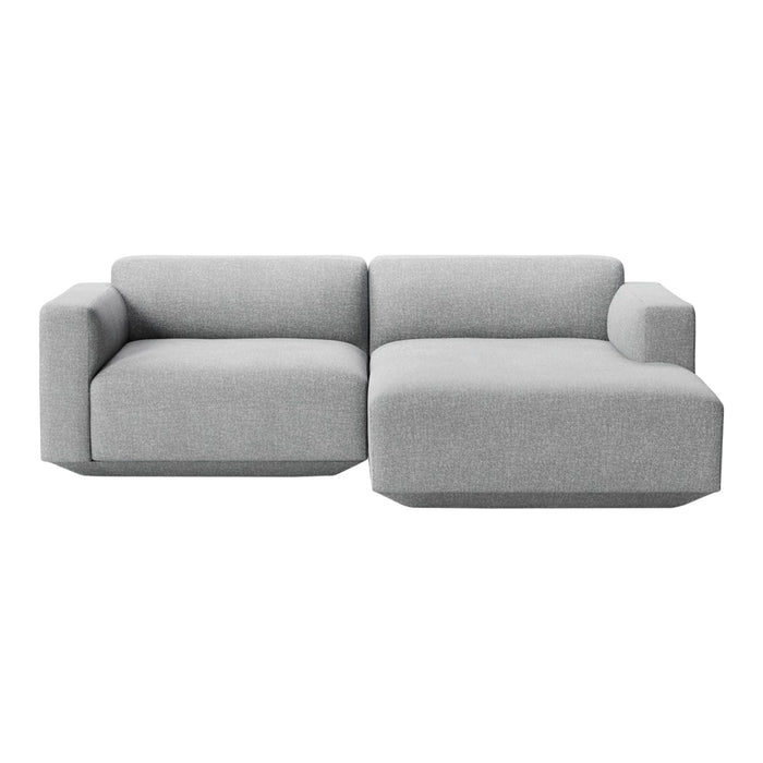 Modern gray sectional sofa with a minimalist design and clean geometric patterns. Soft, textured fabric upholstery.