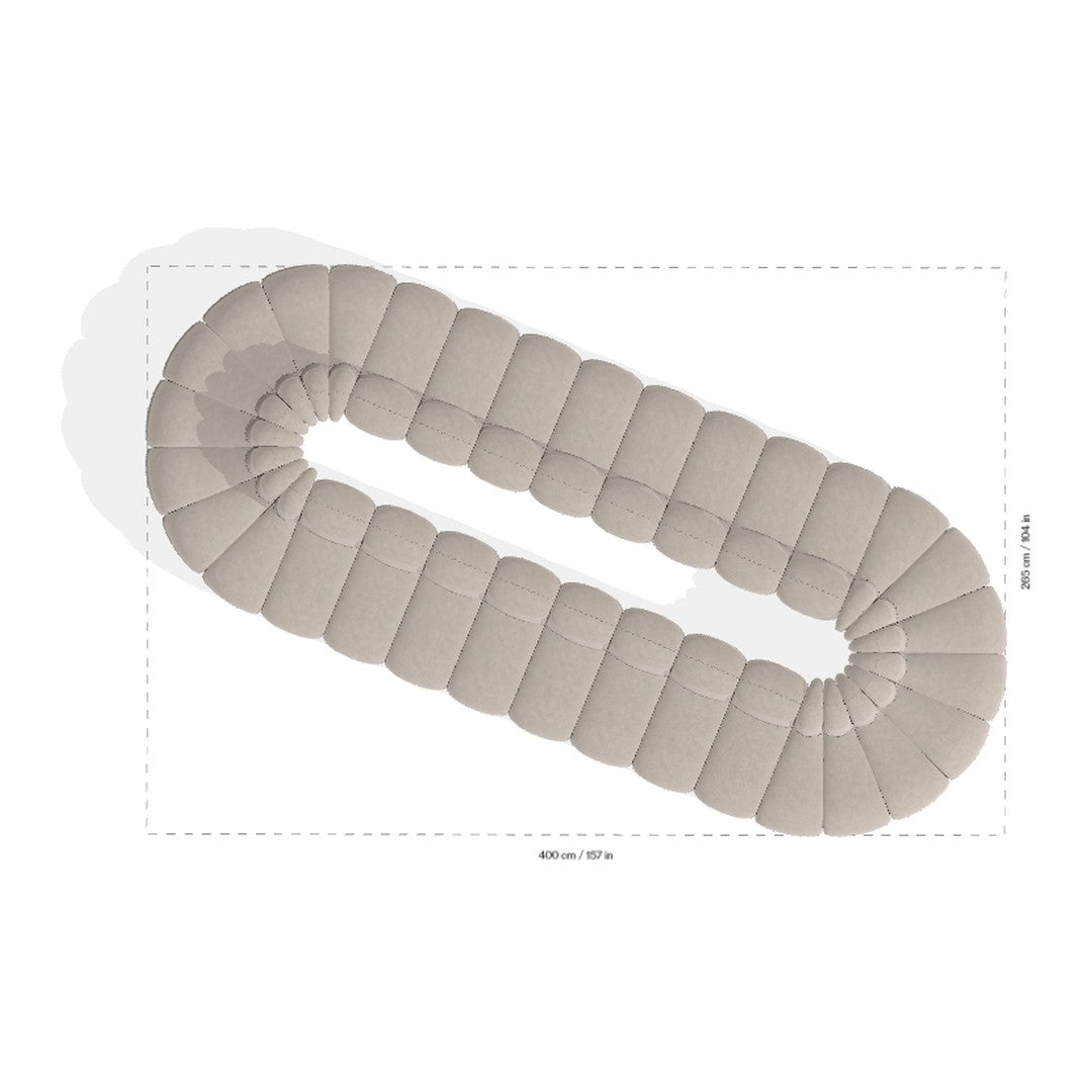 Beige oval rug featuring a plush, tufted design with a smooth, neutral tone and rounded edges. Perfect for any decor.