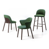 Set of three chairs featuring rich green upholstery and contrasting dark wooden legs. Modern and stylish design.