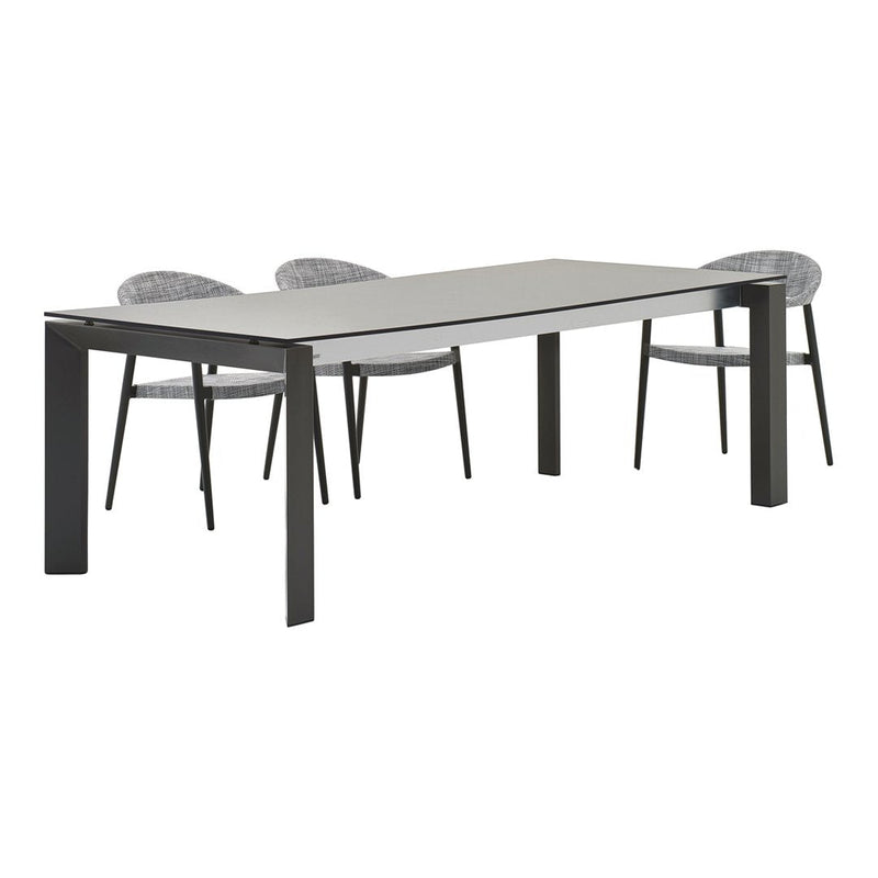 Gray rectangular dining table with black legs and four textured gray chairs. Simple, modern design with minimal patterns.