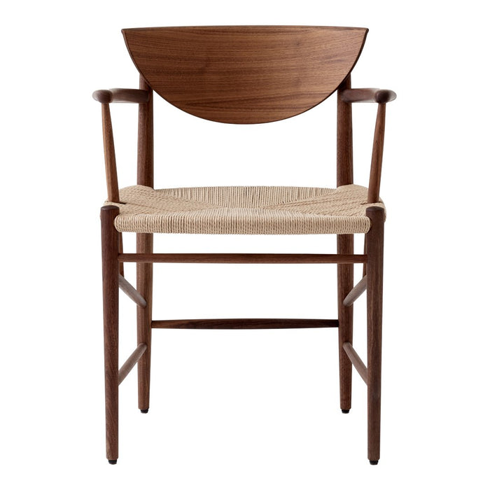 Brown wooden chair with a curved backrest and natural woven seat, featuring a minimalist design and clean lines.