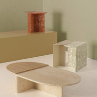 Colorful geometric decorative tables in terracotta, green floral, beige, and natural wood finishes.