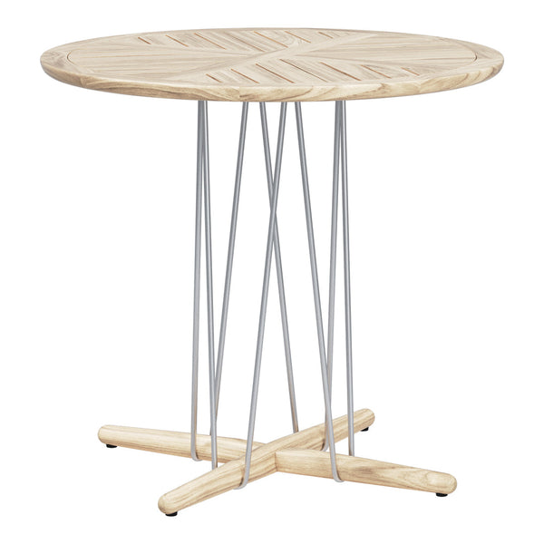 Round wooden table with a light natural finish and geometric patterns, featuring sleek silver metal legs.