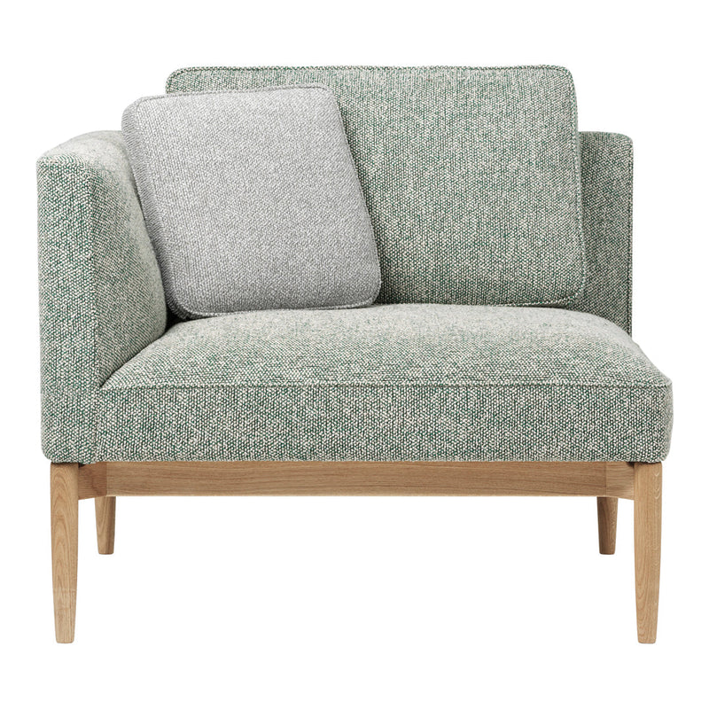 Light green textured upholstery with a gray accent pillow and natural wood legs, perfect for stylish living spaces.