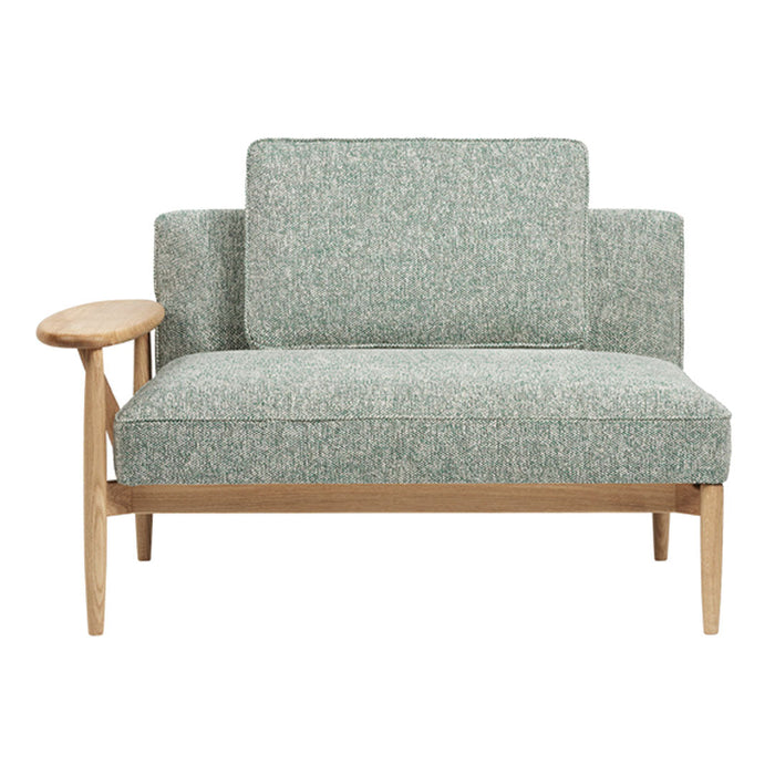 Green patterned upholstery with a textured finish, featuring light wooden armrests and a modern, minimalist design.