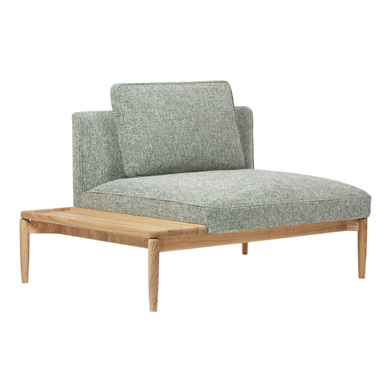 Light green textured fabric armchair with natural wood legs and a minimalist design.