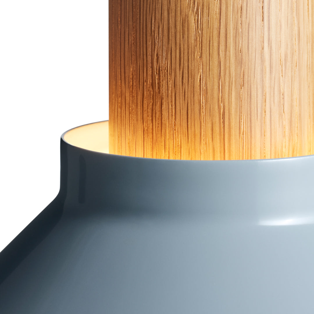 Grey lamp base with a natural wood column and warm glowing light, featuring smooth and sleek design elements.