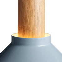 Light gray lamp base with a natural wood pole, featuring a smooth finish and warm glowing light pattern.