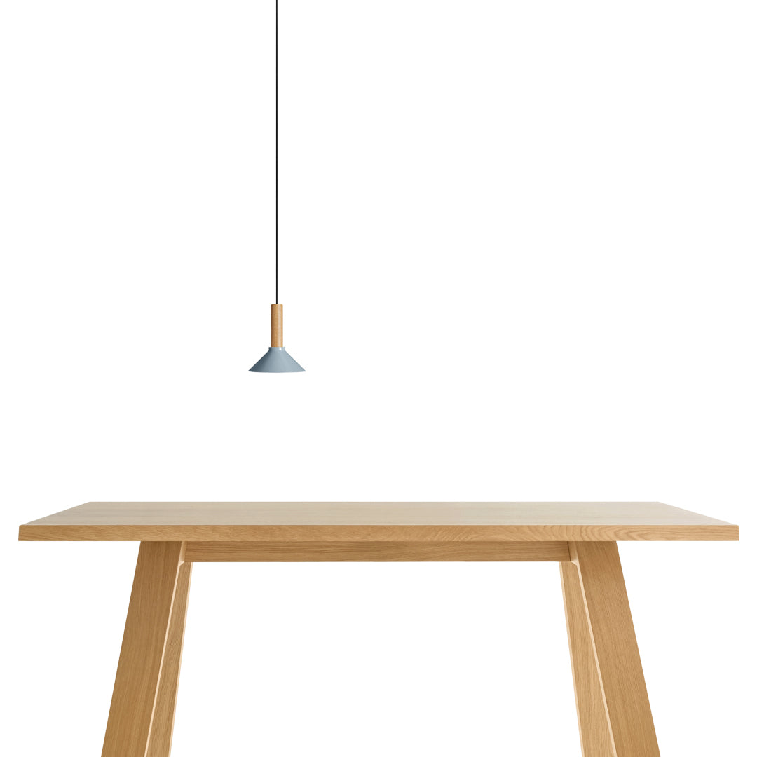 Light wood table with a minimalist design, complemented by a soft blue pendant lamp for a modern touch.